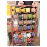 Rolls of Plastic Lanyard Cord on Wood Rack