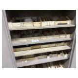 Two door storage cabinet full of pins in all of
