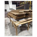 Table containing lots of assorted wood boards,
