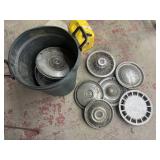 Trash can full of hub caps