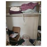 Large group of towels and sheer curtains