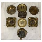 Brass ashtrays and a belt buckle