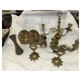 Brass candelabras and holders with a vase as well