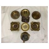 Brass ashtrays and a belt buckle