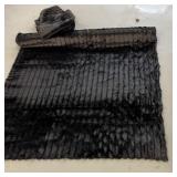 Large roll of soft black cloth