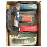 Hand trowels and different grit rub brick and a