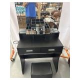 Black and mirrored vanity with electrical outlet