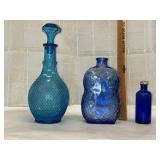 2 glass decanters and a cobalt blue glass bottle