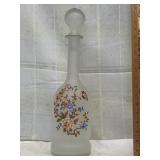 Frosted glass decanter with floral design on it