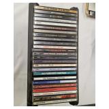 25 assorted CDs & holder