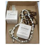 Two Avon perfume, candles, and some necklaces
