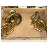 Two brass colored candle holders and two brass