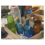 Green blue, amber and clear glass jars with Tom