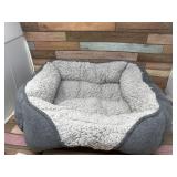 Small grey pet bed (appears gently used)