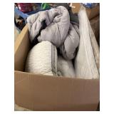 Big box full of blankets, pillows, cushions and