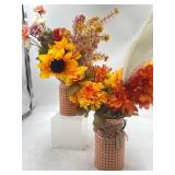 Two fall metal vases with faux flowers that can be