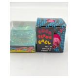 2 squishies   one is a blue cube shaped squishy an