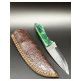 Fixed blade hunting knife with textured steel blad