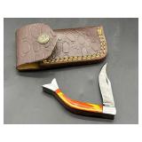 Damascus steel curved skinning knife with red and