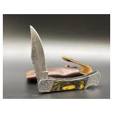 Damascus folding pocket knife with decorative hand