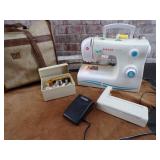 Singer Sewing Machine.  Powers on, needle moves