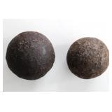 TWO SOLID IRON CANNONBALLS