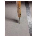 Long Handle with nail on end.