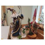 Approximately 12 in tall, resin Santas