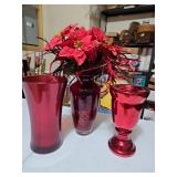 Three red glass vases with poinsettias