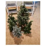 Group of five small Christmas trees