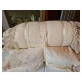 Three small lace covered pillows