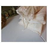 Three small lace covered pillows