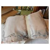 Two, covered and embroidered pillows