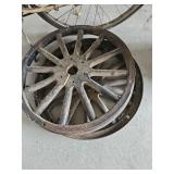 Two metal rimmed wooden spoke wheels