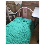 Pink child size trundle bed with mattress and blankets