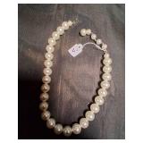 Cream color beaded necklace.