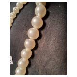 Cream color beaded necklace.