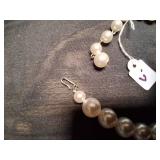 Cream color beaded necklace.