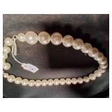 Cream color beaded necklace.