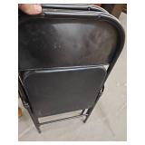 2 black folding chairs