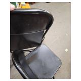 2 black folding chairs