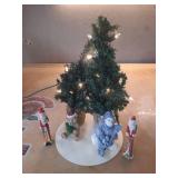 Christmas decoration: small, pre-lit artificial Christmas tree and several figurines