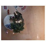 Christmas decoration: small, pre-lit artificial Christmas tree and several figurines