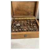 Router bits in wooden case and saw blade