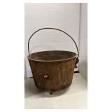 Vintage Cast Iron Footed Bean Pot and an empty kerosine jug