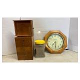 Six small drawers, cat litter (?) and a Clock
