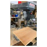 Craftsman 34-inch Radial Drill Press attached to workbench 32x60 ( needs cleaned) also with vise attached.