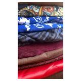 Fabrics, mostly dark, paisley and blue and white flowers