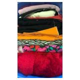 Fabrics, red fuzzy, and more in bin