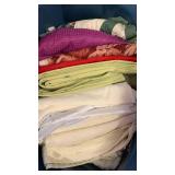 Fabrics, beiges, purple, greens and red
